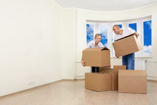 Packed boxes and furniture ready for transport by van
