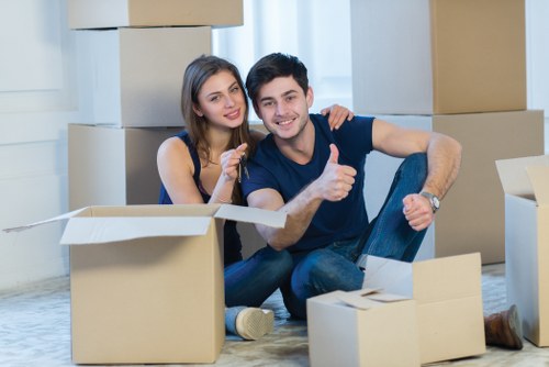 Local movers handling furniture in a Bexleyheath property