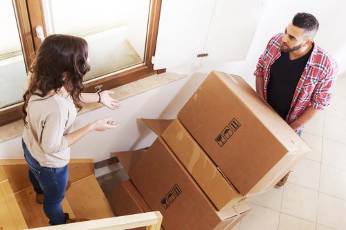 Furniture and boxes being loaded for transport by a local moving team