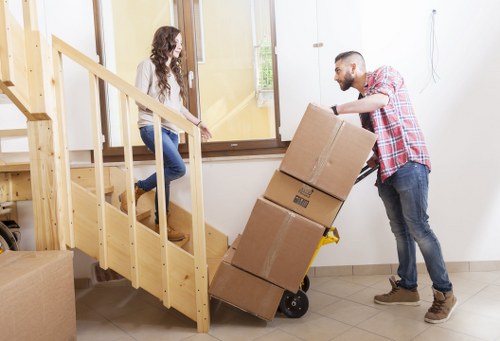 Packed moving boxes and furniture prepared for removal truck hire