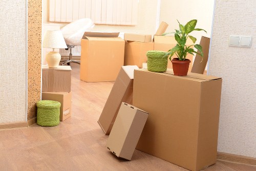 Stacked packing supplies including tape, wrap, and cartons for local customers